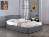 Harlesden grey fabric ottoman bed with the base closed, in a bedroom