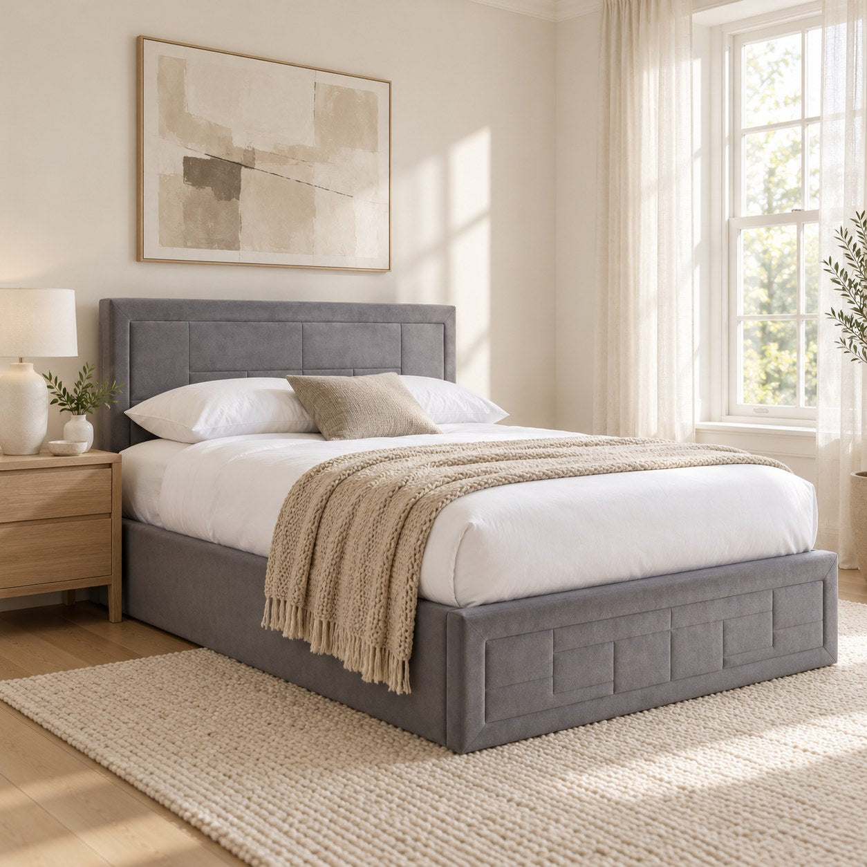 Holland grey velvet ottoman bed with a panelled headboard, in a bright bedroom (AI-generated illustration of this frame; bedding for illustration, mattress not included)