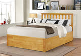 Morden solid rubberwood ottoman bed in oak with the base closed, in a bedroom