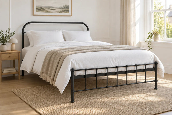 Peckham black iron bed frame, shown in a bright UK bedroom
