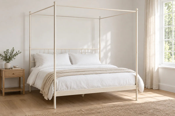 Soho ivory four poster iron bed frame, shown in a bright UK bedroom