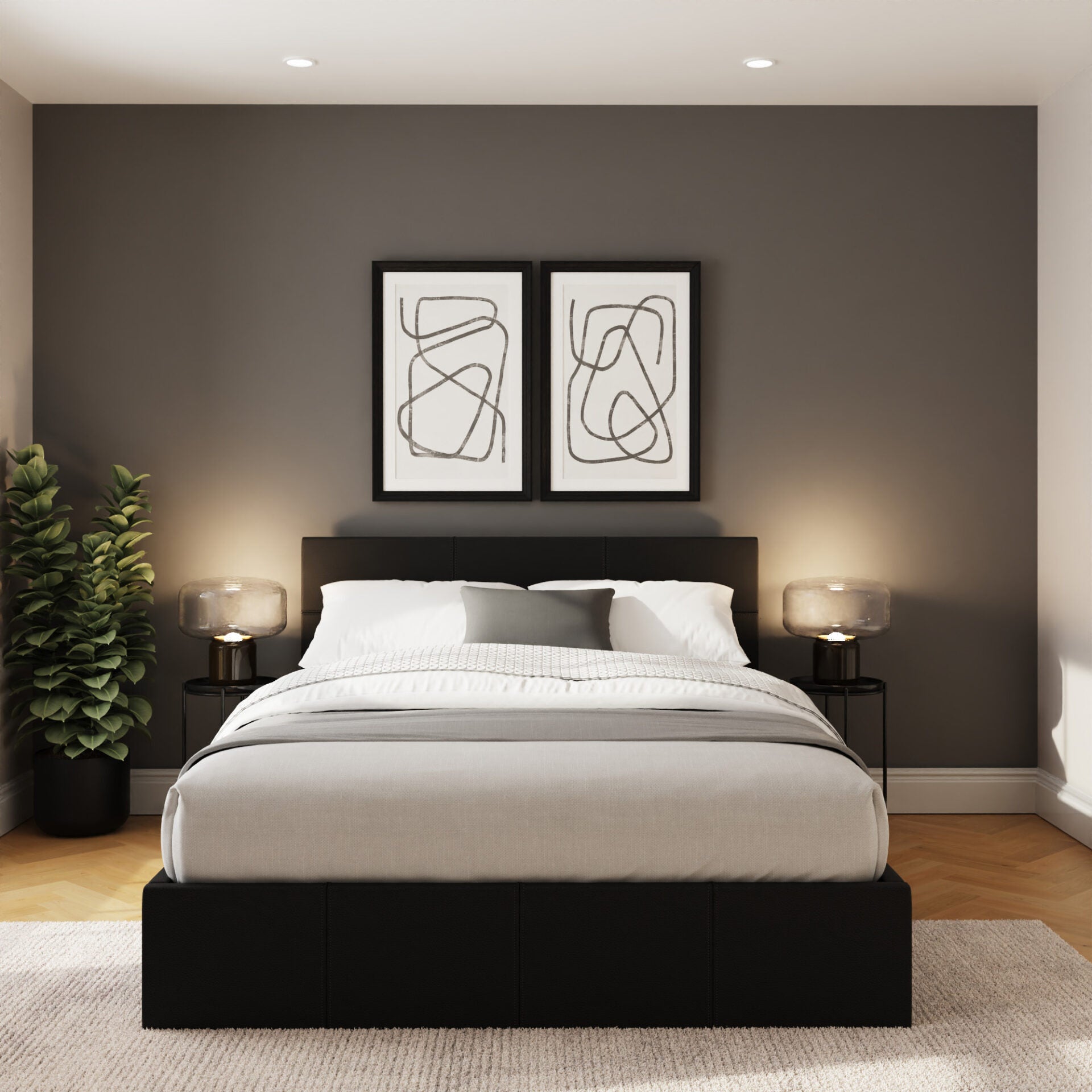 Stratford end lift ottoman bed, in black, in a bedroom with two framed prints