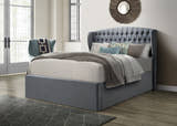 Lewisham velvet ottoman bed in grey velvet, closed, in a bedroom