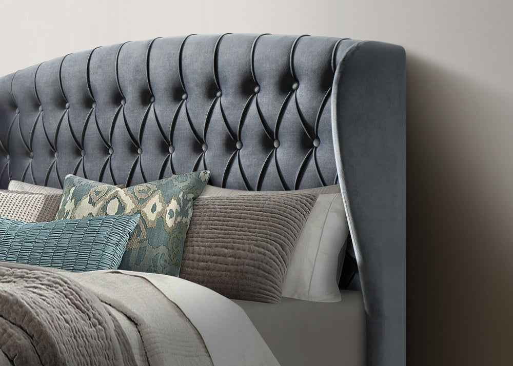 Lewisham velvet ottoman bed in grey velvet, close-up of the buttoned winged headboard