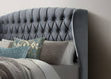 Lewisham velvet ottoman bed in grey velvet, close-up of the buttoned winged headboard