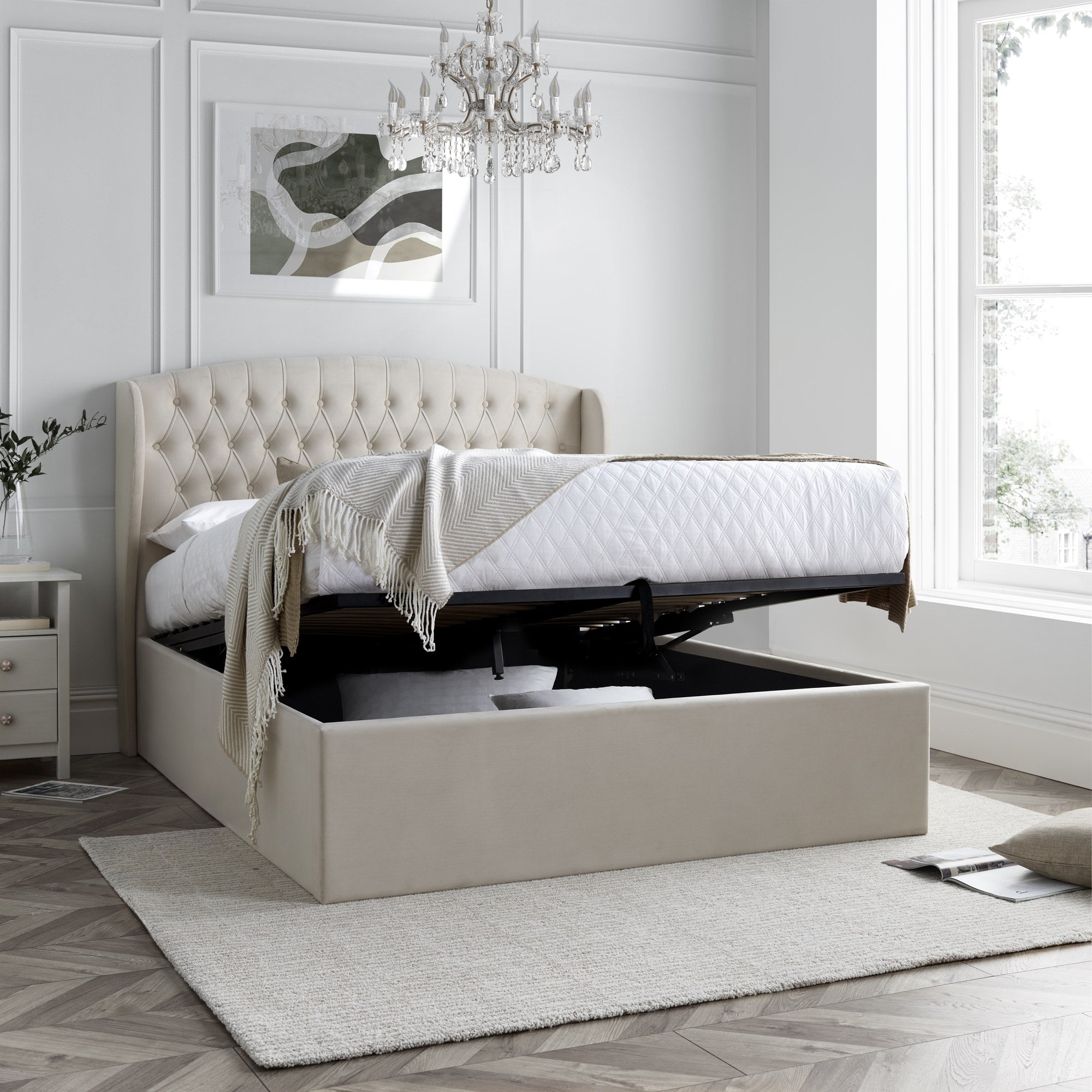 Lewisham velvet ottoman bed in natural velvet, with the storage half open