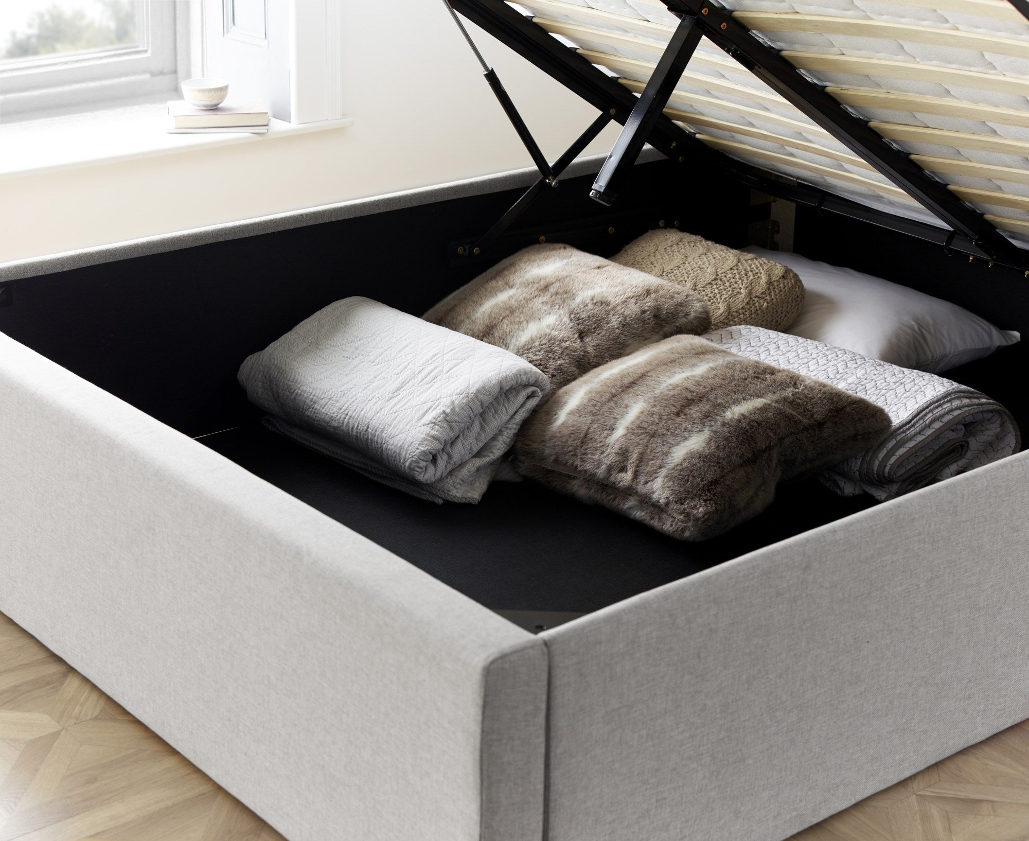 Wembley fabric ottoman bed in grey, inside the fully boarded storage
