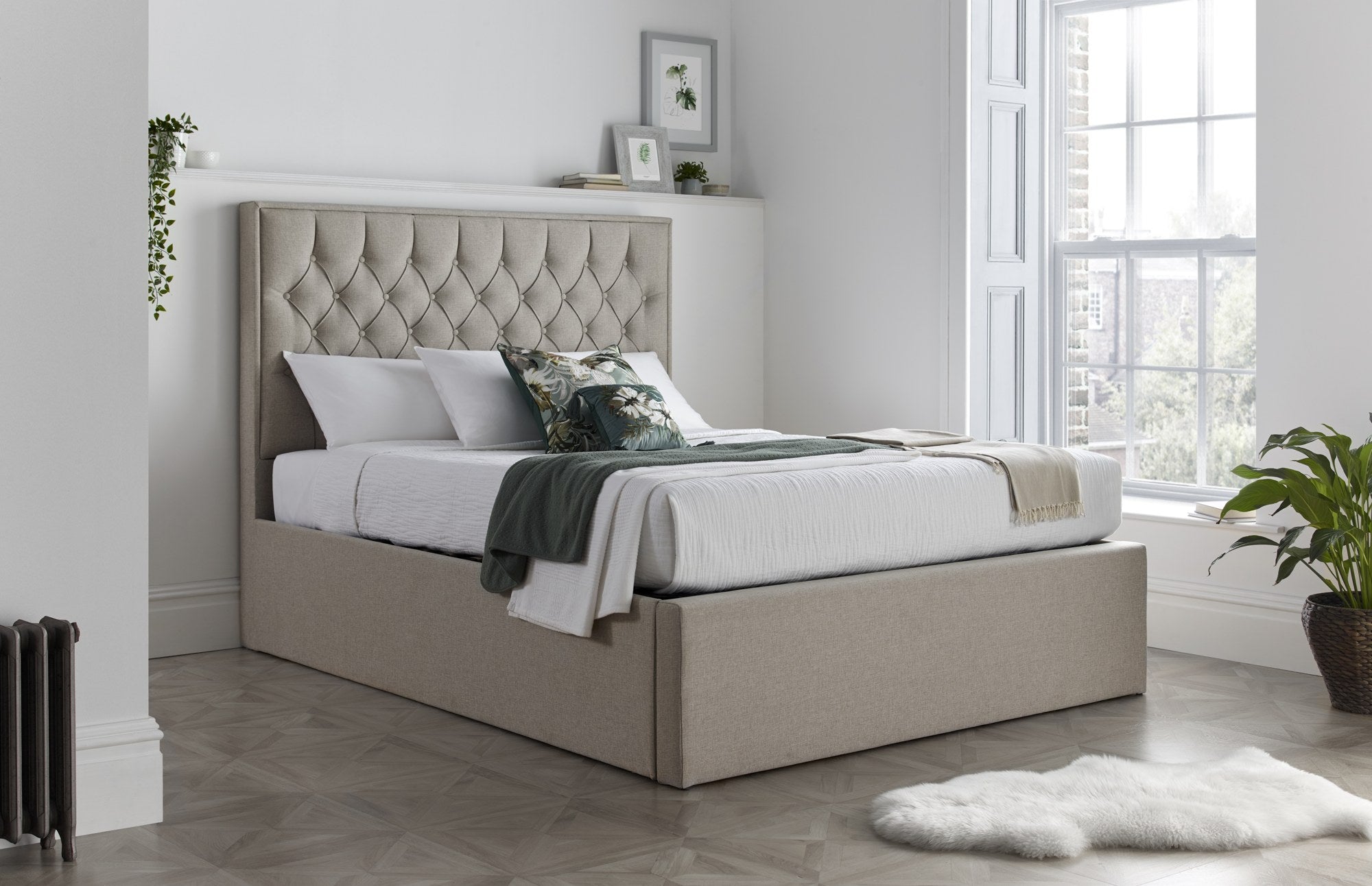 Wembley fabric ottoman bed in oatmeal, closed, in a bedroom