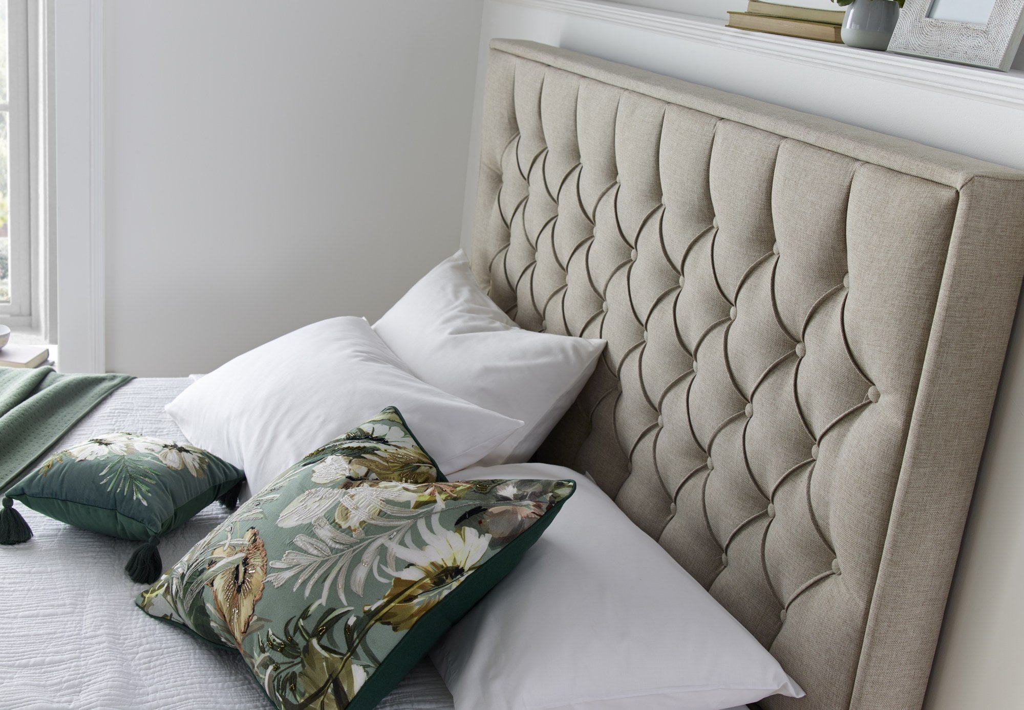 Wembley fabric ottoman bed in oatmeal, close-up of the buttoned headboard