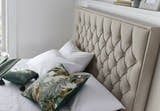 Wembley fabric ottoman bed in oatmeal, close-up of the buttoned headboard